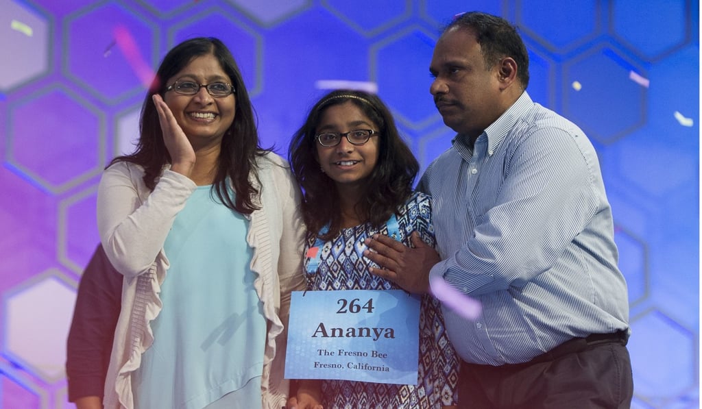 Ananya Vinay, 12, from Fresno, Calif., celebrates onstage with her parents, Anu Pama Poliyedathpp, left, and Vinay Sreekumar, right, after winning the 90th Scripps National Spelling Bee in Oxon Hill, Maryland, last Thursday. Photo: AP