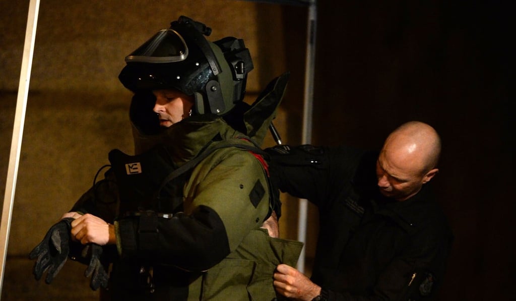 A bomb squad member suits up ahead of entering a residential building in the Melbourne bayside suburb of Brighton on Monday. Photo: AFP A bomb squad member suits up ahead of entering a residential building in the Melbourne bayside suburb of Brighton on Monday. Photo: AFP