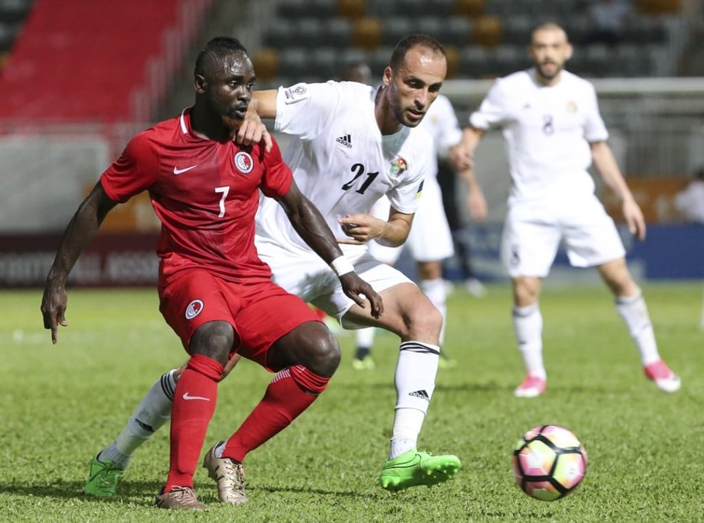 Hong Kong’s Karikari Godfred (left) takes on Jordan’s Mohammad Aldmeiri at Mong Kok Stadium. Photo: K. Y. Cheng