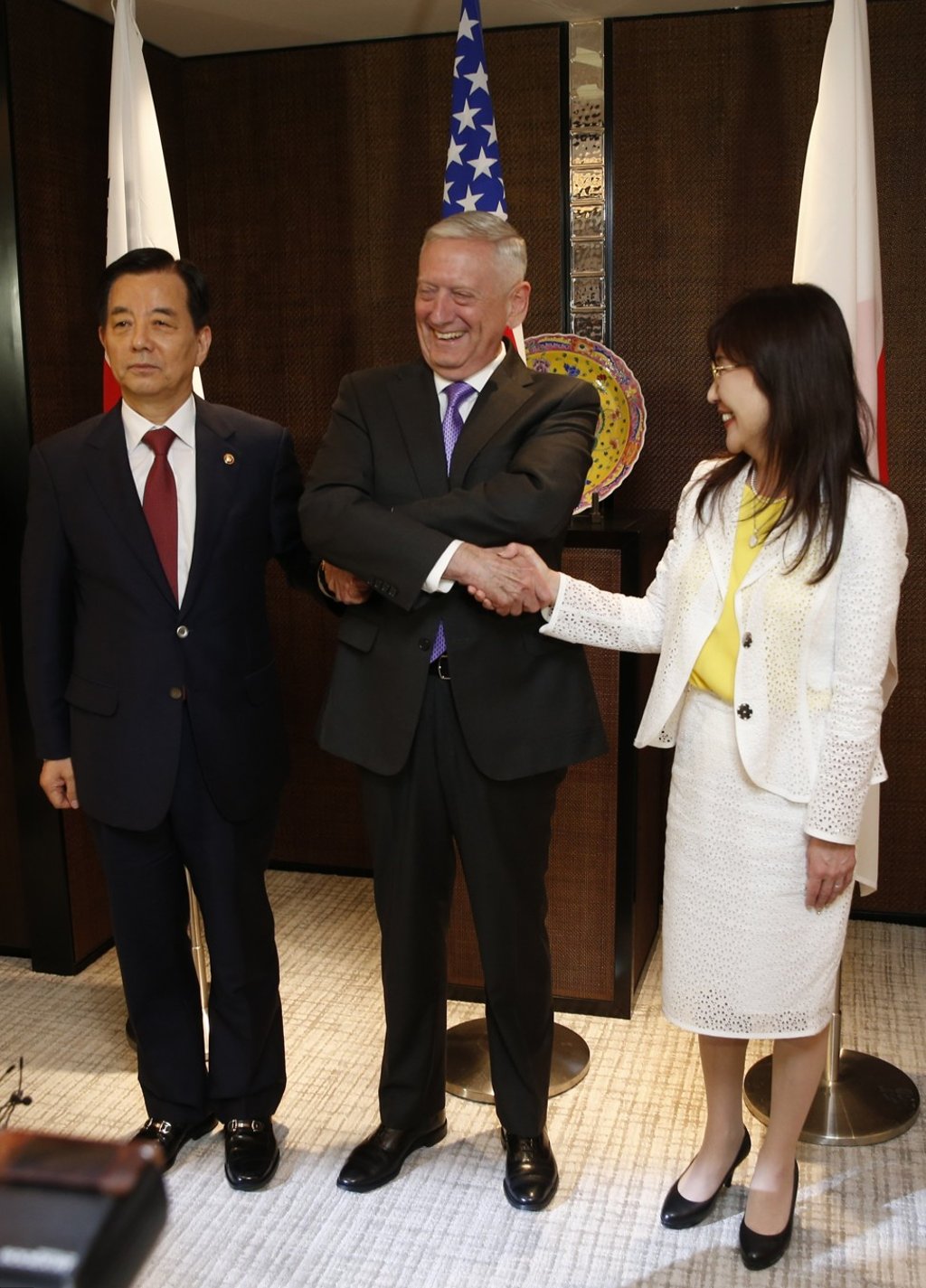 Linking hands ahead of a trilateral meeting of national defence chiefs are (from left) South Korea’s Han Min-goo, James Mattis of the US and Japan’s Tomomi Inada, in Singapore on June 3. The meeting took place as part of the 16th Asia Security Summit, an annual gathering of defence officials from the Asia-Pacific. Photo: EPA