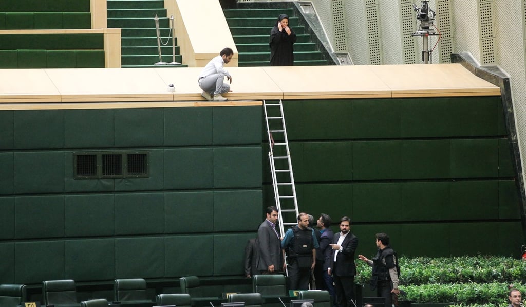 Iranian policemen deploy in the main hall of the Iranian parliament to protect lawmakers during the attack by Islamic State. Photo: AFP Iranian policemen deploy in the main hall of the Iranian parliament to protect lawmakers during the attack by Islamic State. Photo: AFP