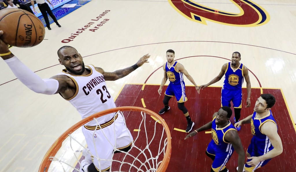 Cleveland Cavaliers forward LeBron James (left) goes to the basket for two points during the first half of the NBA Finals game three against the Golden State Warriors. Photo: EPA