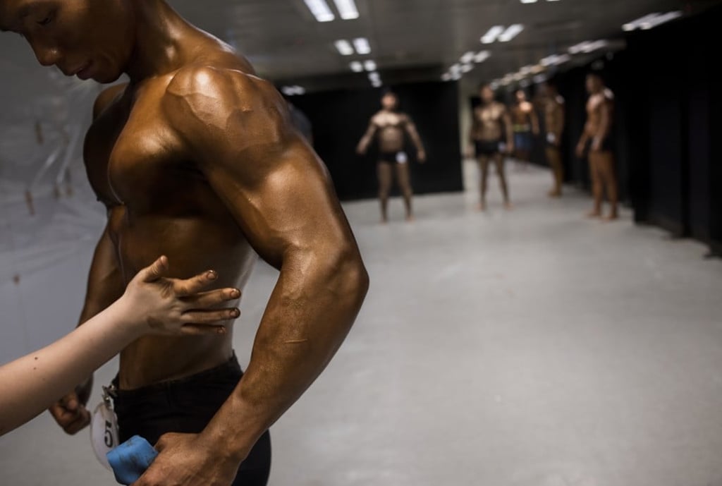 A competitor gets tanning product applied.