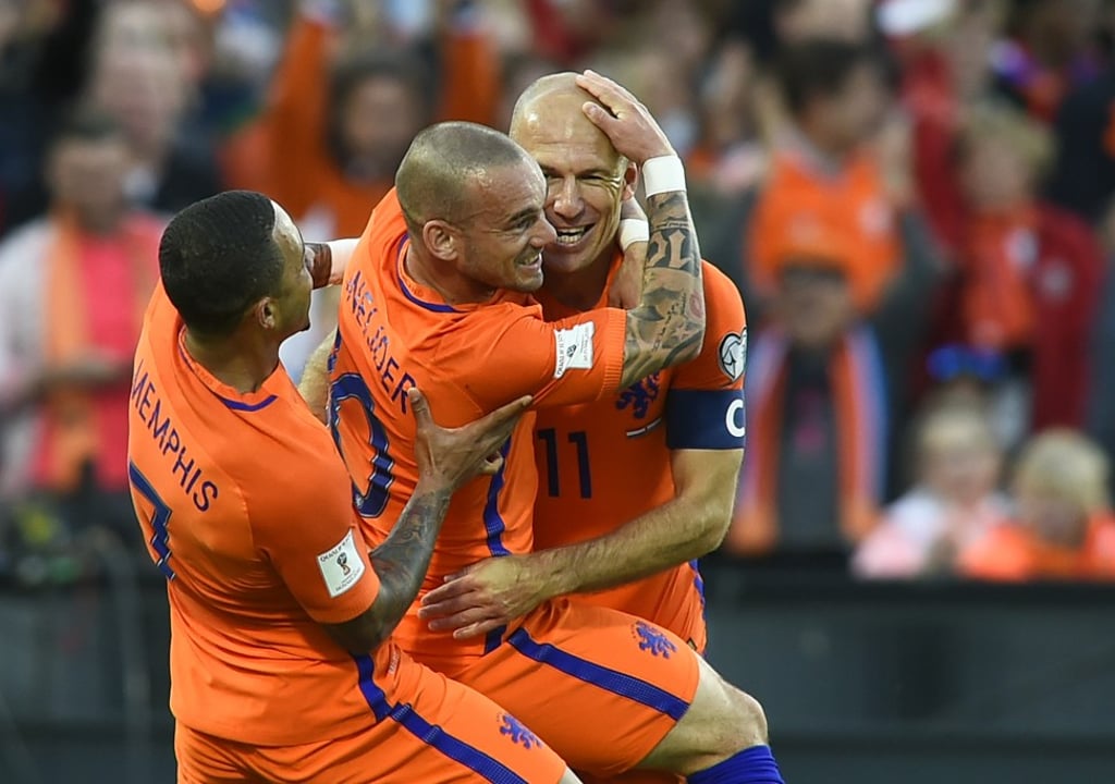 Wesley Sneijder (centre) celebrates with Arjen Robben (right). Photo: AFP