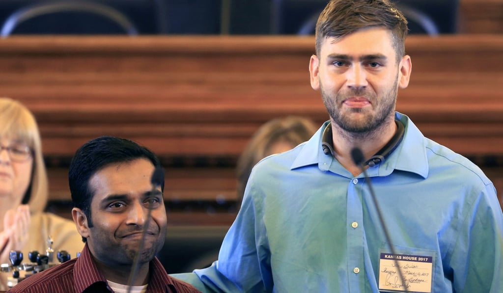 Alok Madasani, left, and Ian Grillot, right, embrace and smile after they were honoured by the Kansas House of Representatives in Topeka, Kansas. Adam Purinton was charged with shooting them last February in a bar and he was eventually charged with hate crimes. Photo: AP