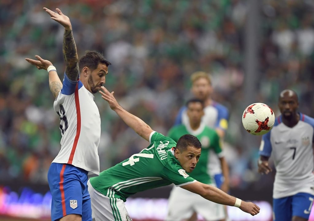 Mexico’s Javier Hernandez vies for the ball with USA’s Geoff Cameron. Photo: AFP