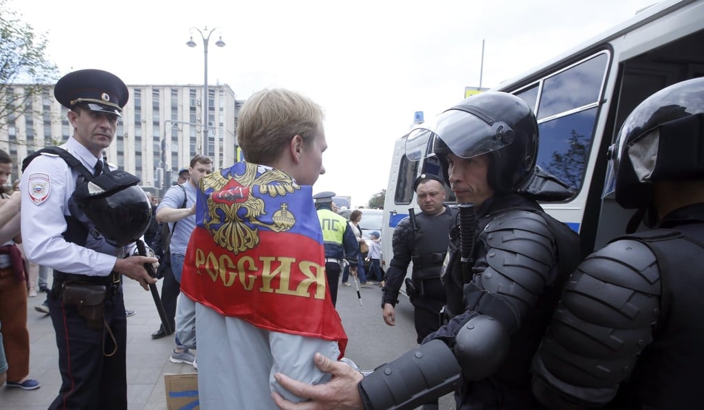 Russian police officers detain a participant of an unauthorised opposition rally in Tverskaya street in central Moscow. Photo: EPA