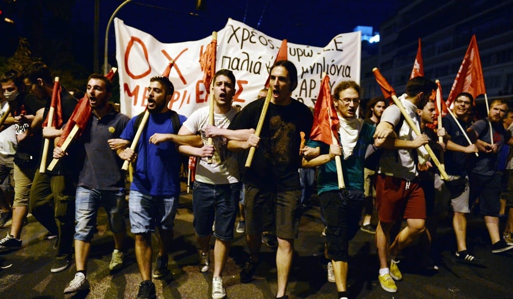 Demonstrators in front of the Greek parliament in Athens protest against austerity measures sought by the EU, on July 15, 2015. The protests came as lawmakers began debating deeply unpopular reforms needed to unlock a new euro-zone bailout for Greece. Photo: AFP