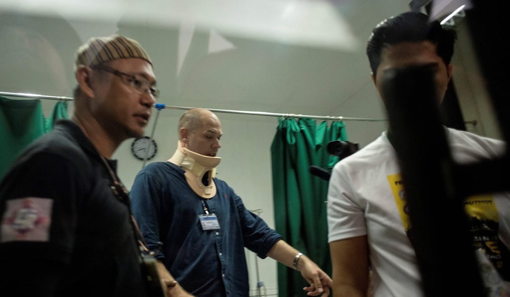 ABC journalist Adam Harvey wears a neck brace inside a clinic at the Lanao Del Sur Provincial Capitol in Marawi. Photo: AFP