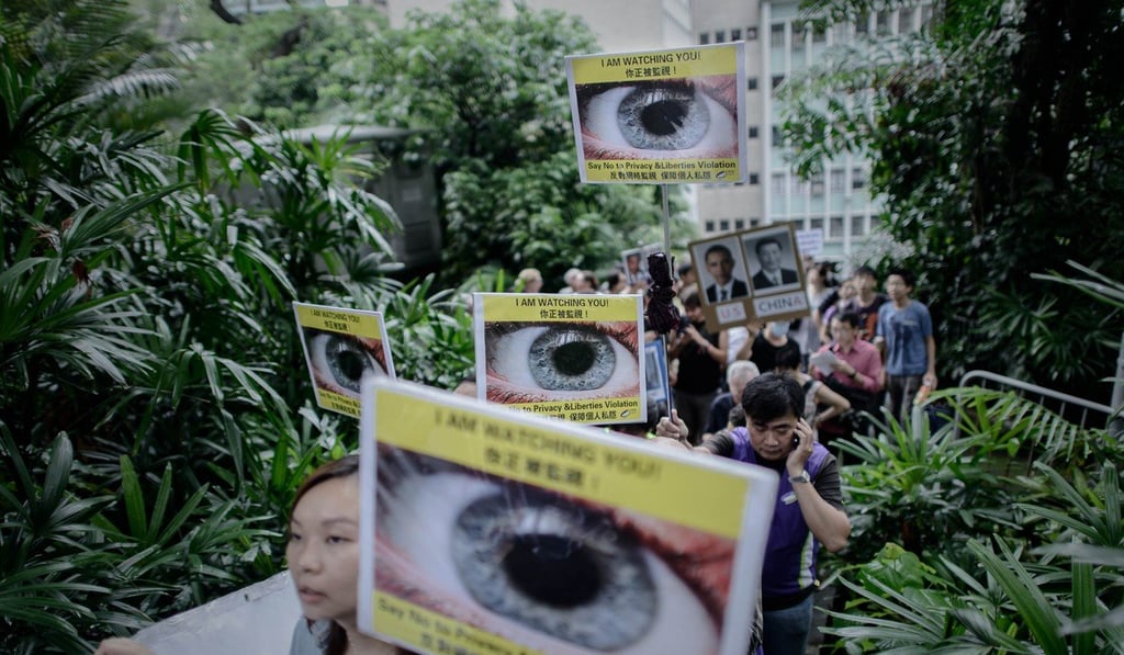 Protesters hold placards as they march to the US consulate in support of Edward Snowden in Hong Kong on June 15, 2013. Snowden, a former CIA technical assistant, blew the lid on a vast electronic surveillance operation by the NSA. Photo: AFP