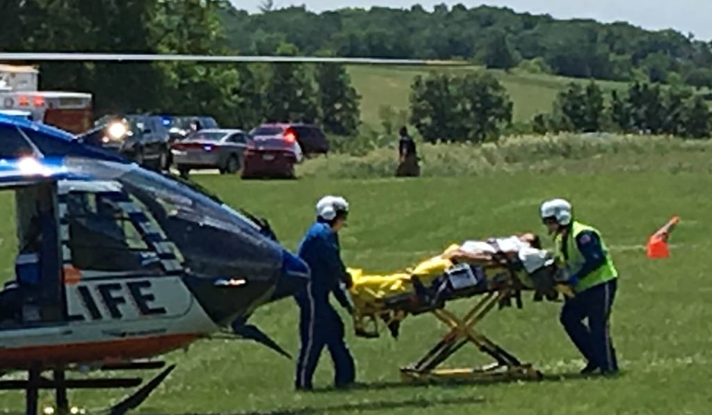 Medical personnel transport the injured pilot of a blimp that crashed in a field near the US Open. Photo: USA TODAY