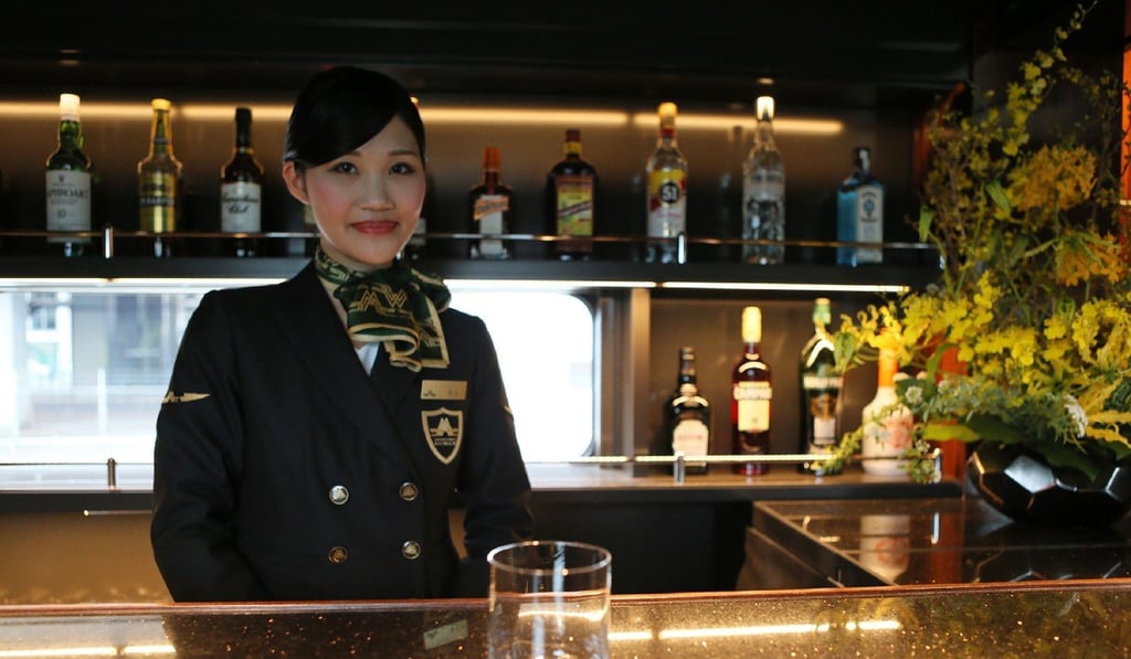 A hostess at a bar counter of Japan's latest super-deluxe cruise train