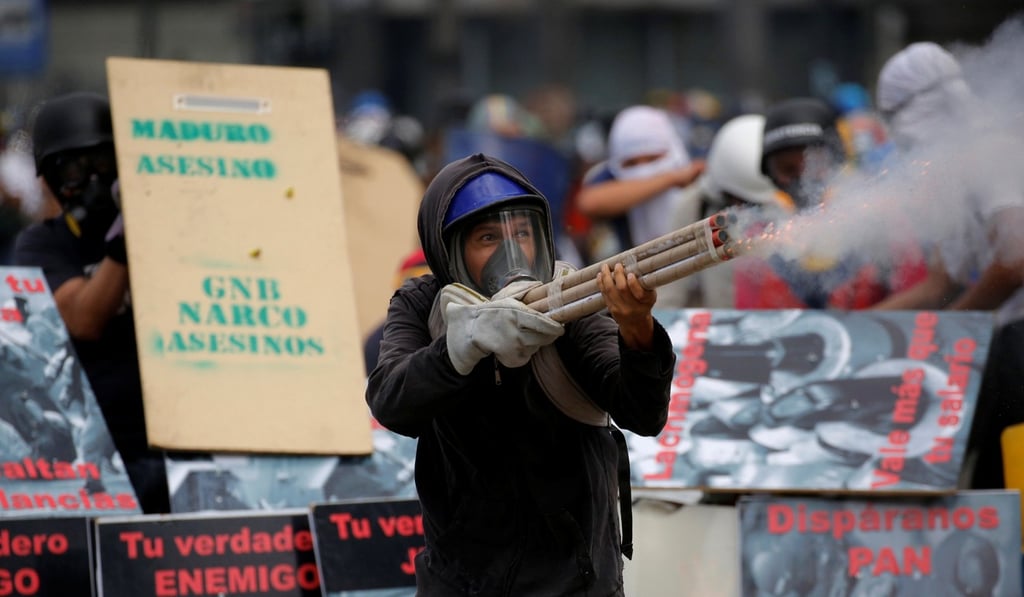 Demonstrators clash with riot security forces in Caracas. Photo: Reuters