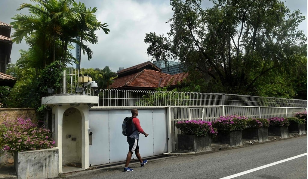 A man walks past the house of Singapore’s late founding father Lee Kuan Yew at Oxley Rise in Singapore. The family feud centres on Lee’s will, and his wish to have this modest home of his last 70 years demolished. Photo: AFP