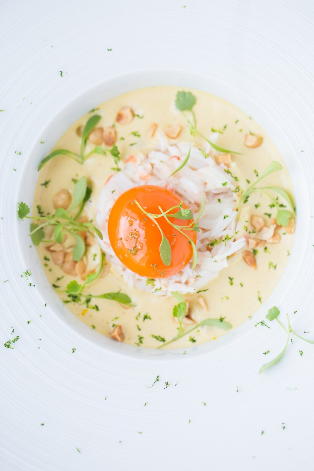 Crab laksa with confit egg, leeks, coriander, hazelnut and sudachi lime from Caprice.