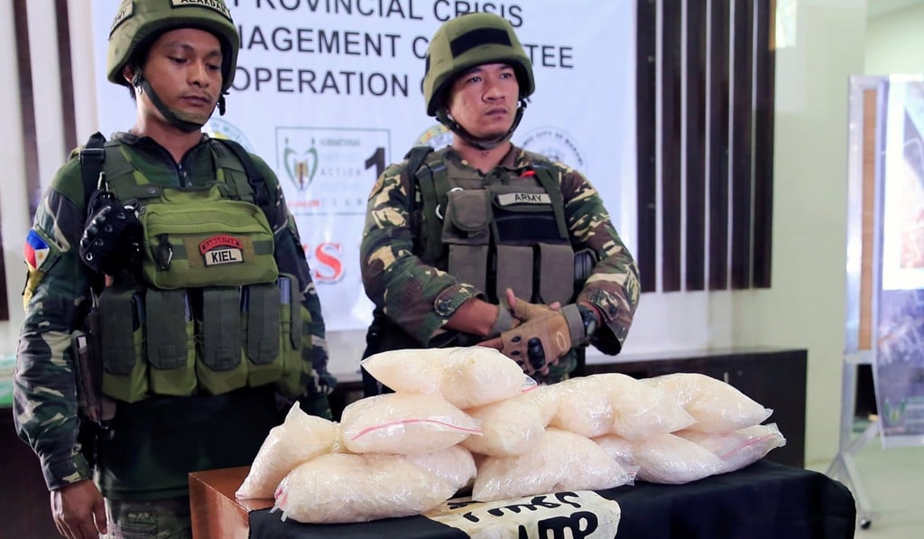 Government forces display 11kg of high grade methamphetamine and the IS flag recovered by troops from the Maute group. Photo: Reuters