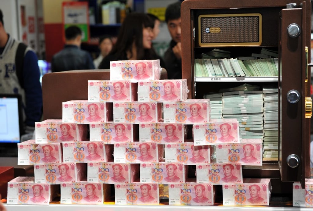 Chinese 100 yuan bank notes, 1.5 million yuan in total, are stacked up in a department store in Shenyang city, Liaoning province, during a sale promotion. The department store is giving out the cash to customers who spend a certain sum of money in shopping as reward. Photo: Imaginechina