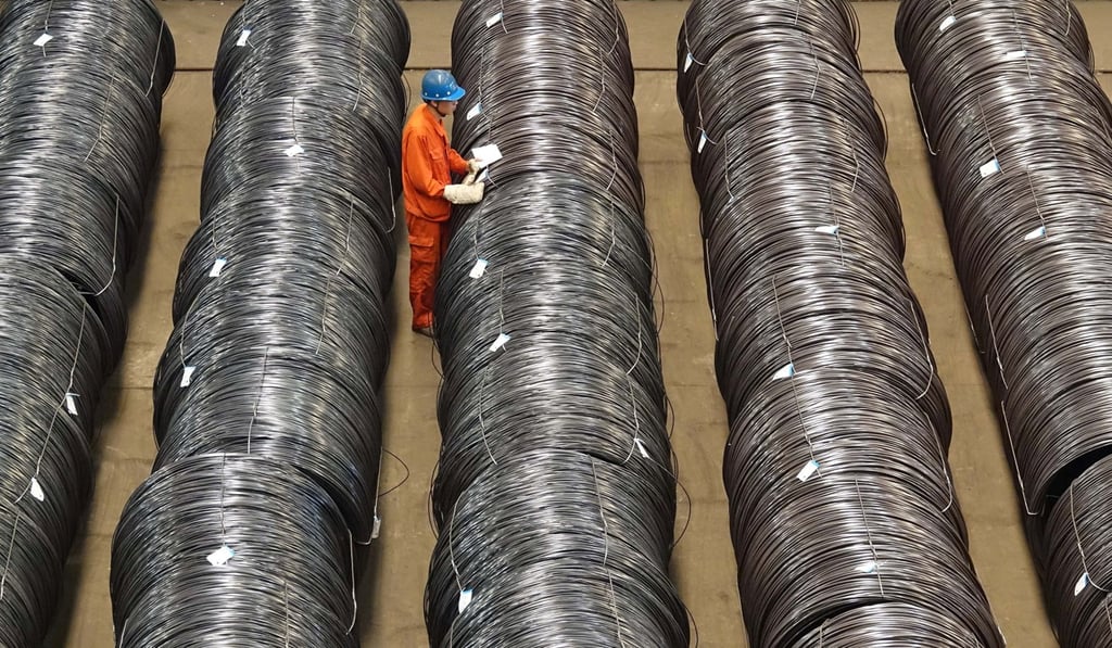 A worker checks steel wires at a warehouse in Dalian, Liaoning province. Photo: Reuters.