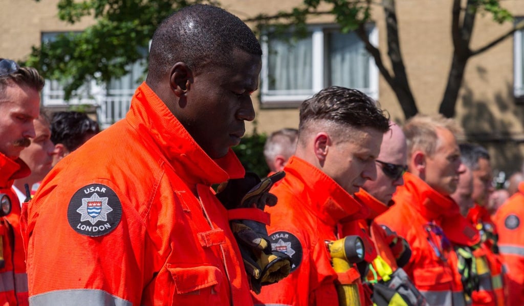 Members of the London Fire Brigade and emergency services observe a minute silence outside Notting Hill Methodist Church for the victims of the Grenfell Tower Fire in London. Photo: Xinhua Members of the London Fire Brigade and emergency services observe a minute silence outside Notting Hill Methodist Church for the victims of the Grenfell Tower Fire in London. Photo: Xinhua