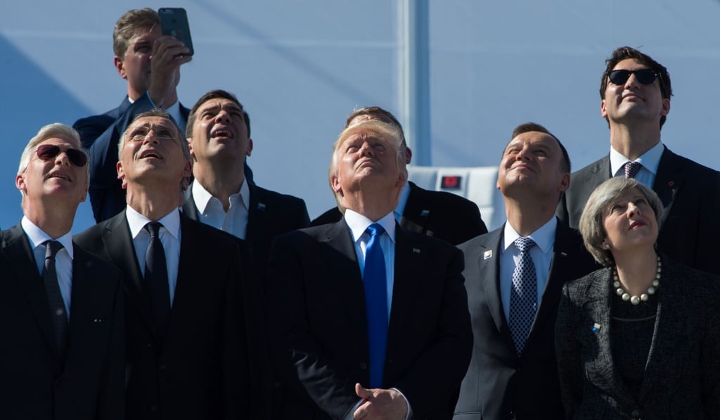 (From left) King Philippe of Belgium, Nato secretary general Jens Stoltenberg, Greek Prime Minister Alexis Tsipras, US President Donald Trump, Poland's President Andrzej Duda, Britain's Prime Minister Theresa May and Canada’s Prime Minister Justin Trudeau watch planes flying during the handover ceremony of the new Nato headquarters in Brussels in May. Photo: AFP