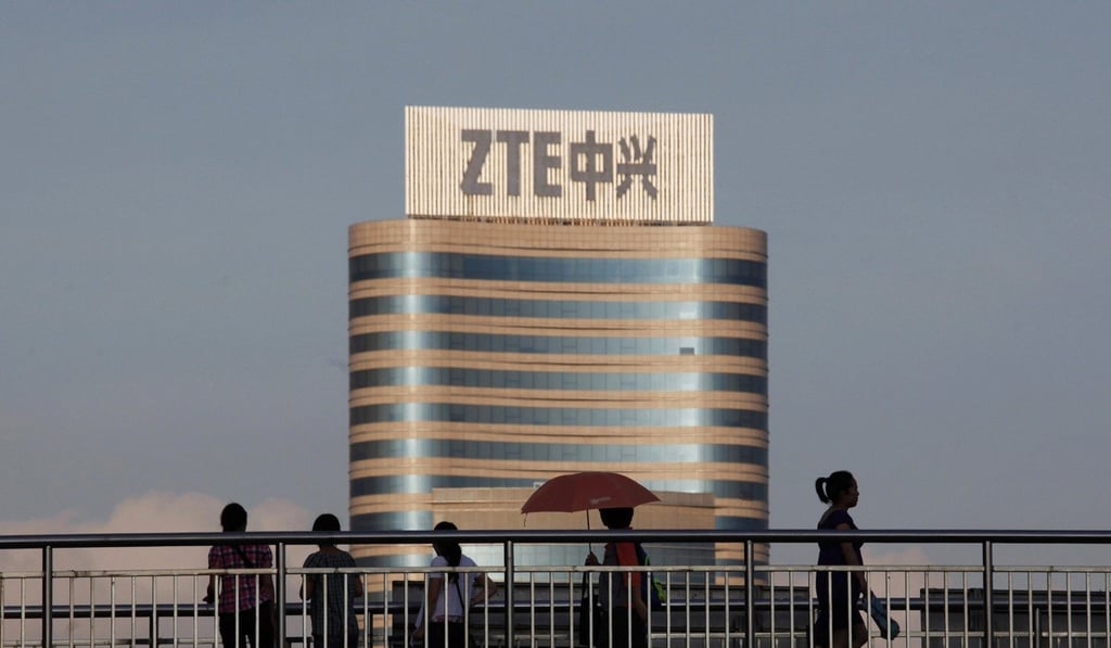 Passersby walk along a footbridge in front of the ZTE building in Nanshan Hi-Tech Industrial Estate, Shenzhen. Photo: Reuters
