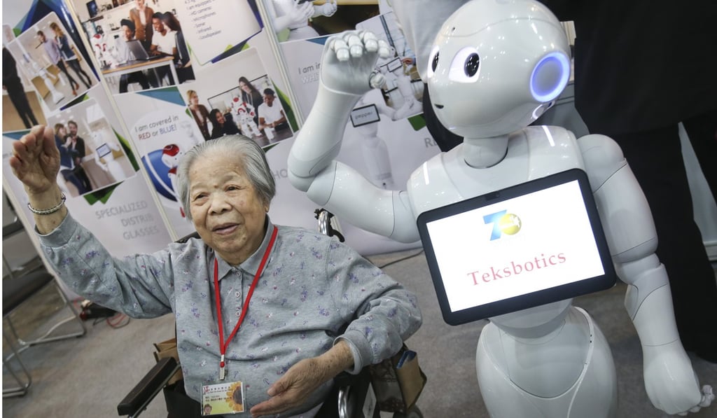 A woman exercises following the lead of a robot instructor, at the Gerontech and Innovation Expo in Wan Chai last weekend. Photo: David Wong