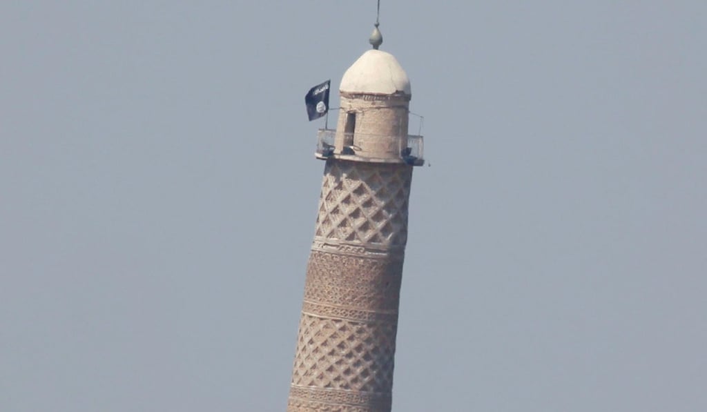 A flag of Islamic State militants is seen on top of Mosul's Al-Hadba minaret at the Grand Mosque, where Islamic State leader Abu Bakr al-Baghdadi declared his caliphate back in 2014. File photo: Reuters
