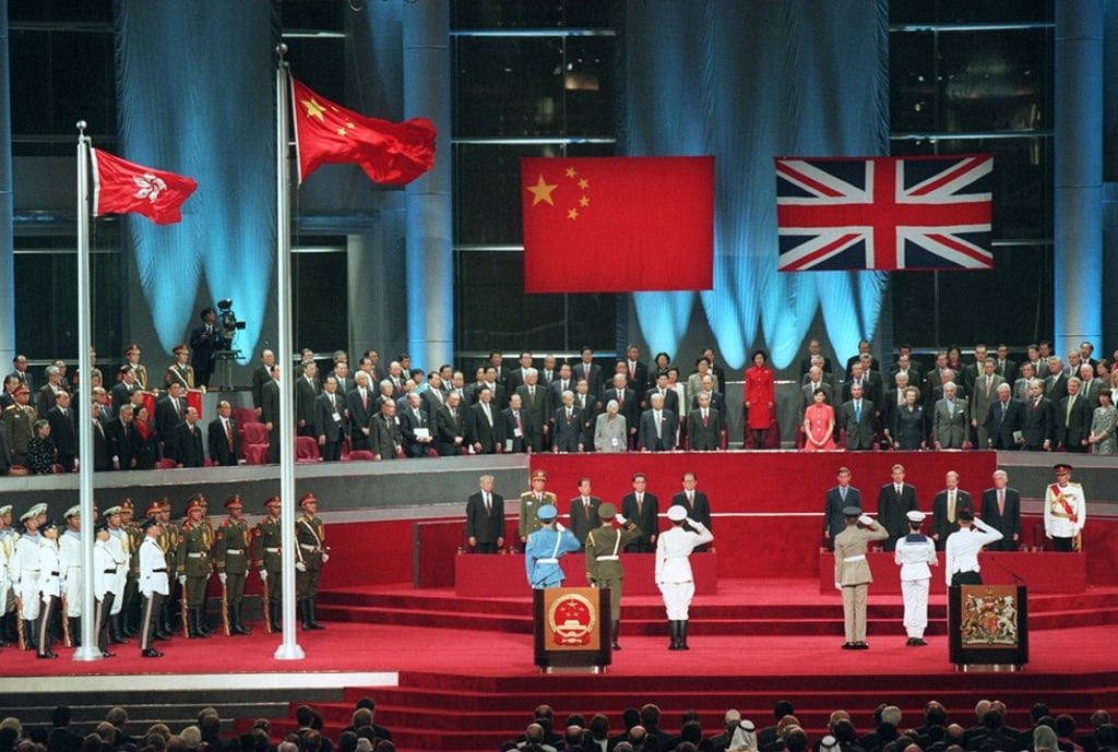 The lowering of the British flag at the handover ceremony. Photo: Robert Ng