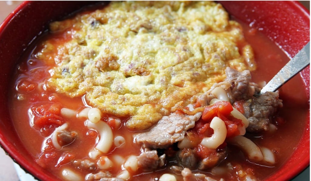 Tomato broth with macaroni, meat and a fried egg at Sing Heung Yuen in Central.
