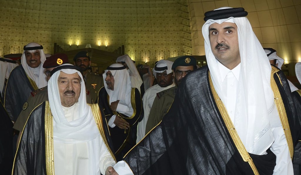 Kuwait's Emir Sheikh Sabah Al Ahmad Al Sabah, left, holds the hand of Qatar's Emir Sheikh Tamim bin Hamad Al Thani in Doha, Qatar, on June 7. Photo: AP