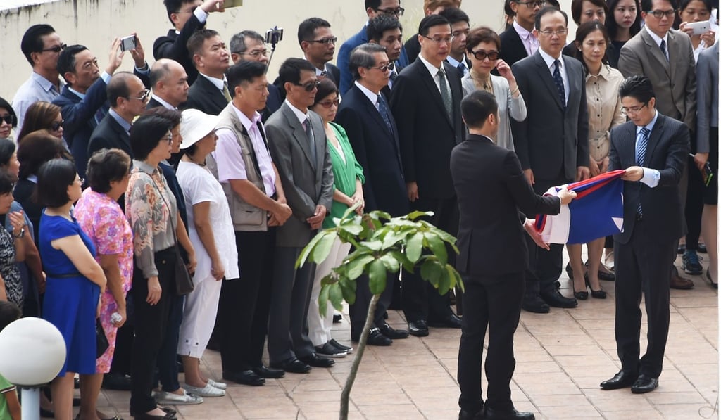 Taiwanese diplomatic personnel attend a flag recall ceremony atop the Taiwanese embassy in Panama City. Photo: AFP