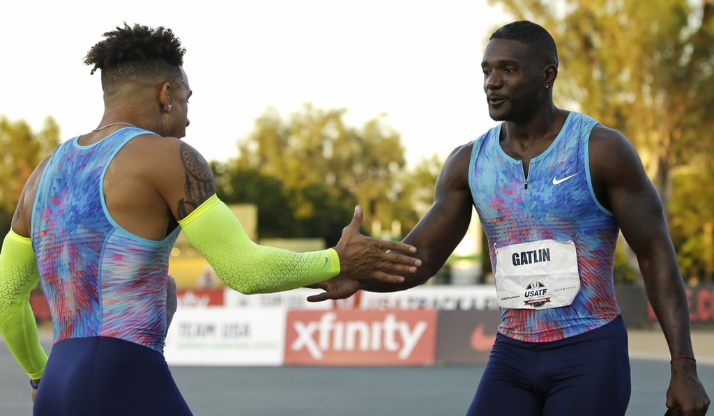 Justin Gatlin (right) shakes hands with Christopher Belcher.