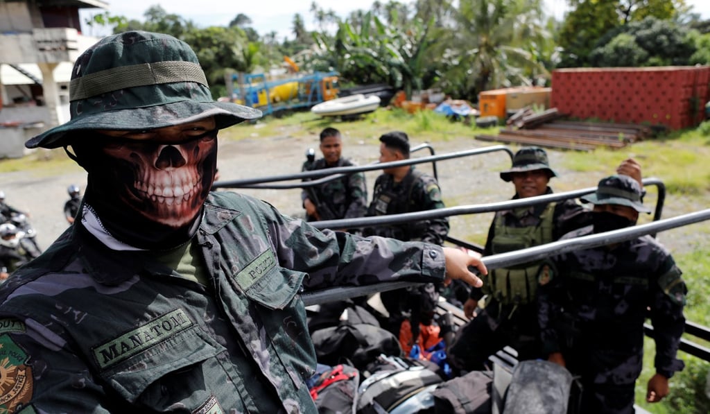 Members of the Philippine National Police Special Action Force ride on a truck in Iligan. Photo: Reuters