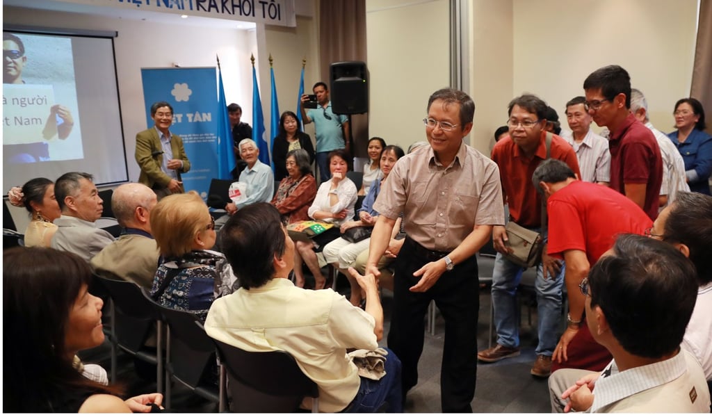 Pham Minh Hoang at a community meeting in hotel in the Paris suburb of Le Kremlin-Bicetre after arriving in France. Photo: AFP