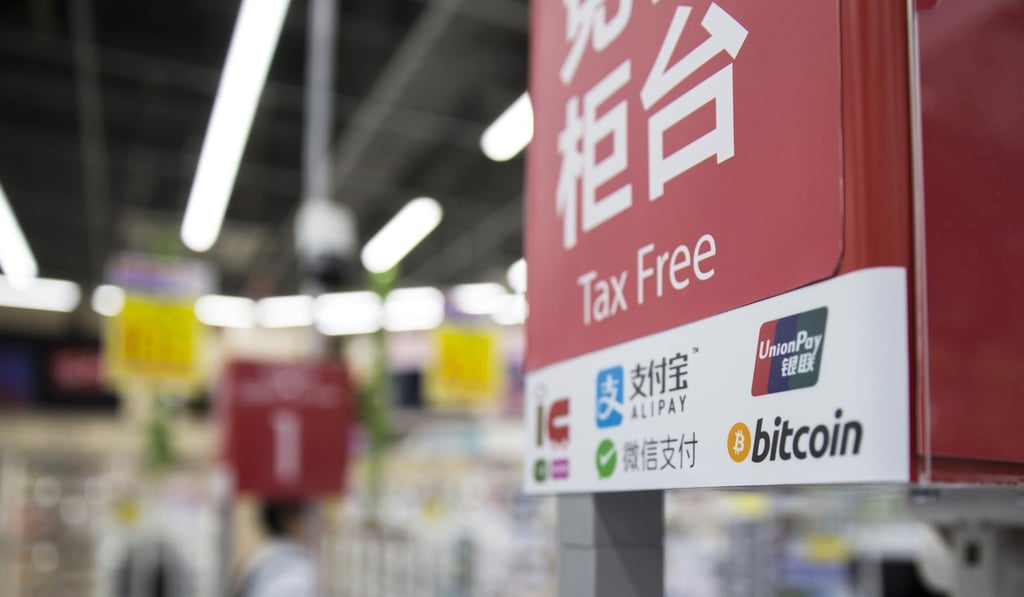 The logos of China UnionPay and Bitcoin are seen at an electronics store in Tokyo. Photo: Bloomberg The logos of China UnionPay and Bitcoin are seen at an electronics store in Tokyo. Photo: Bloomberg