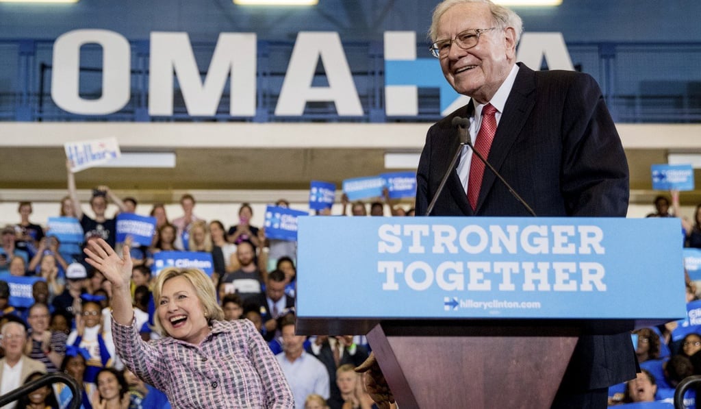 Democratic presidential candidate Hillary Clinton waves to the audience as she and Warren Buffett, chairman and CEO of Berkshire Hathaway, arrive at a rally in Omaha, on August 1 last year. Photo: AP