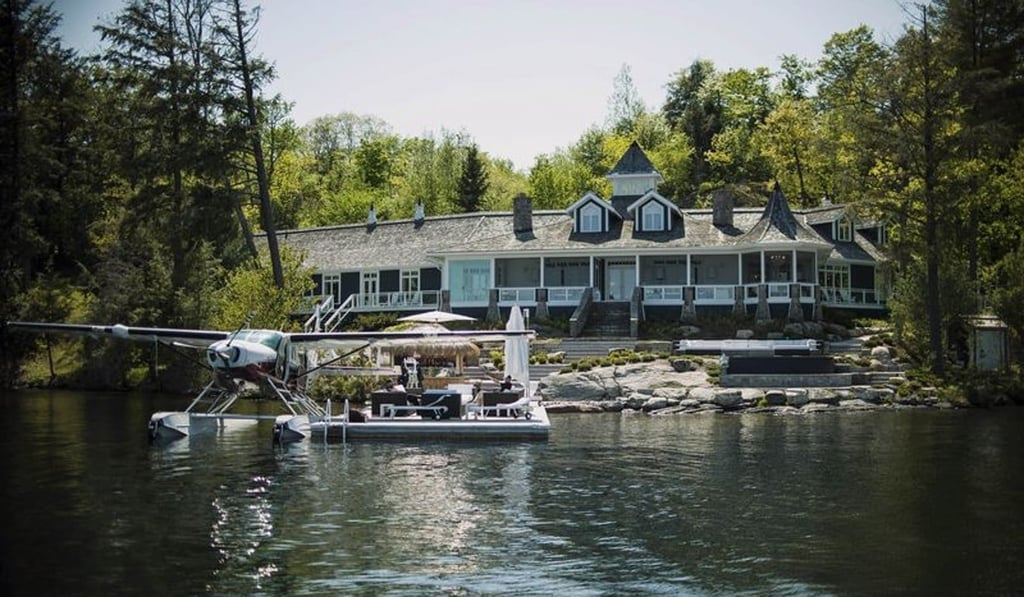 A float plane sits docked outside of a cottage on Lake Jo in Muskoka, Ontario, Canada