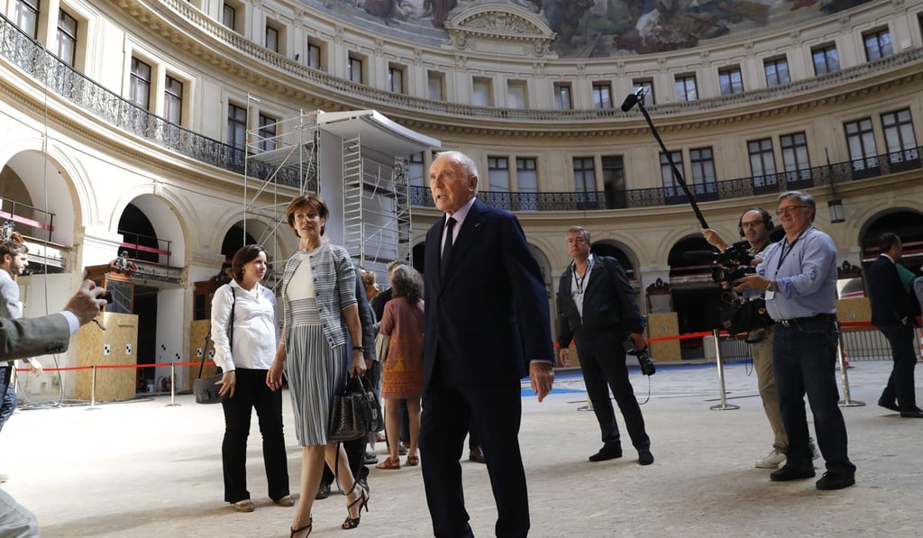 French businessman Francois Pinault (C) tours the former stock exchange building within the presentation of the project for the future museum of the Pinault Foundation. Photo: AFP