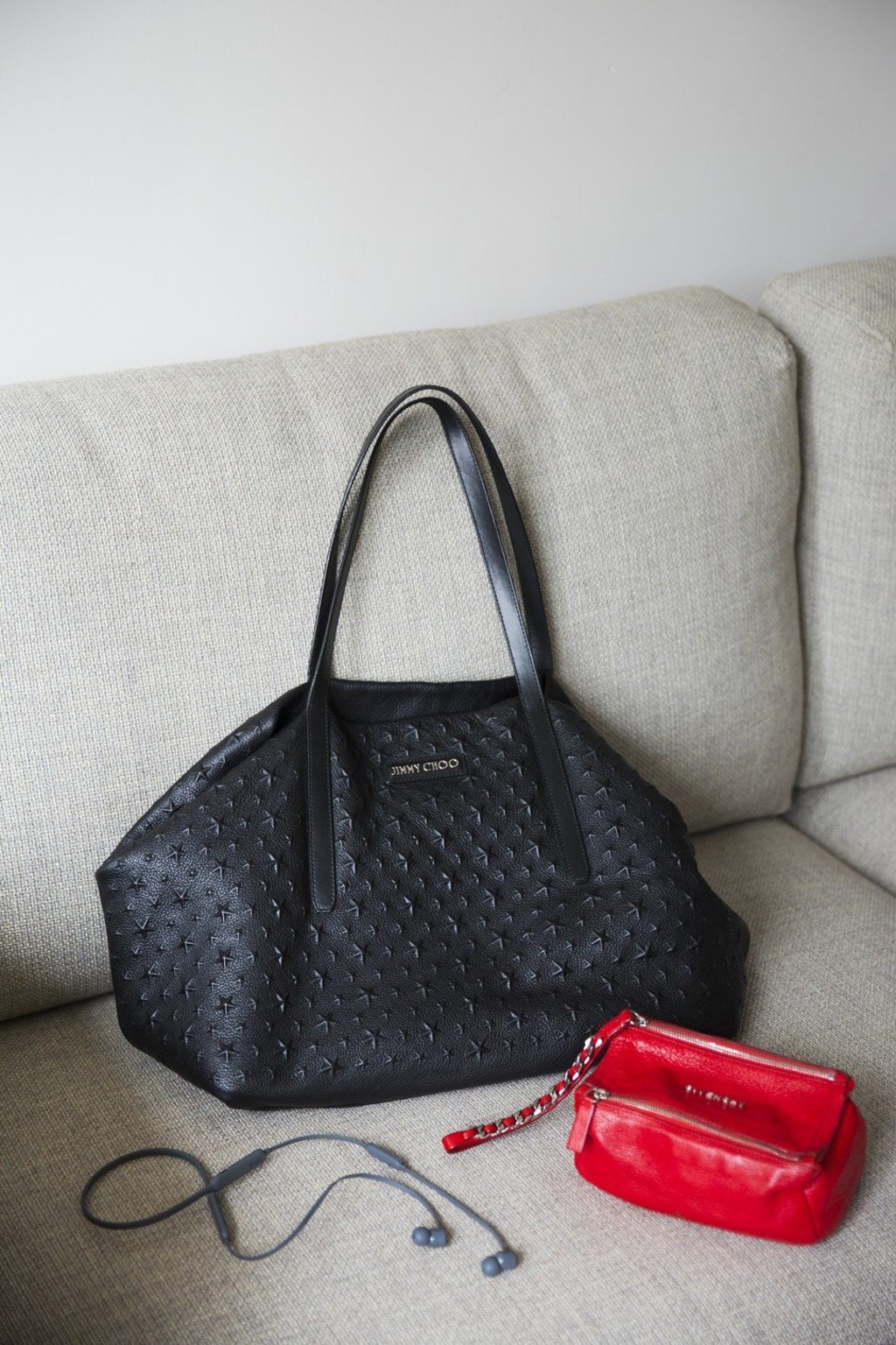 Black Jimmy Choo tote bag, red Givenchy purse and BeatsX earphones. Photo: Michelle Wong