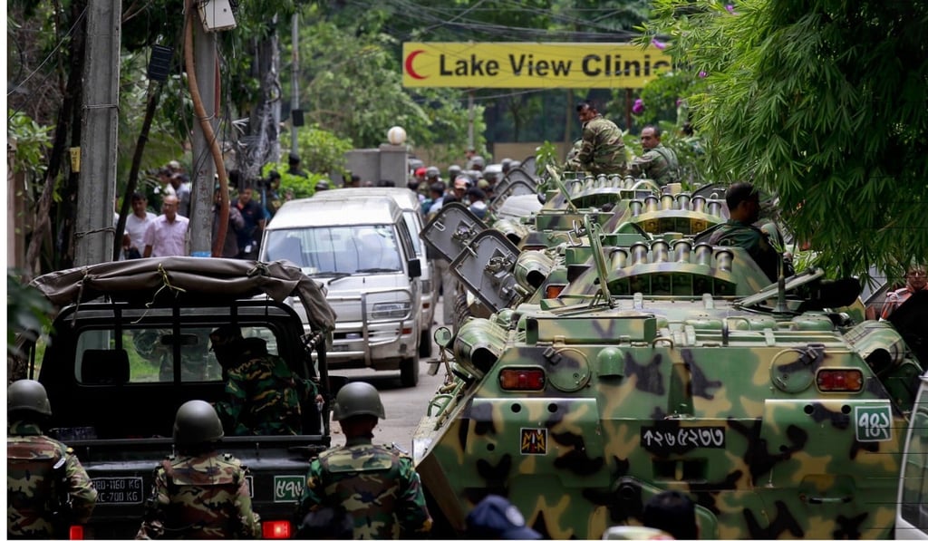 Bangladesh security personnel surround a cafe after militants took hostages, several of them from Japan. Photo: AP
