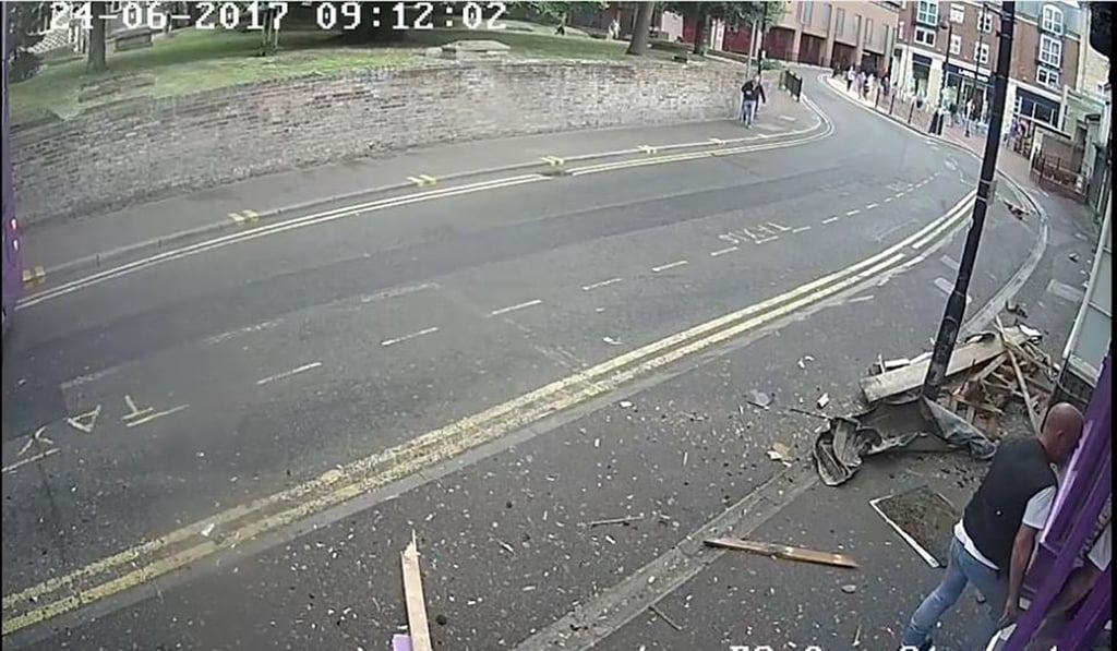 ... before dusting himself off and nonchalantly entering the Purple Turtle pub, seven seconds after being struck. Photo: BBC / YouTube ... before dusting himself off and nonchalantly entering the Purple Turtle pub, seven seconds after being struck. Photo: BBC / YouTube