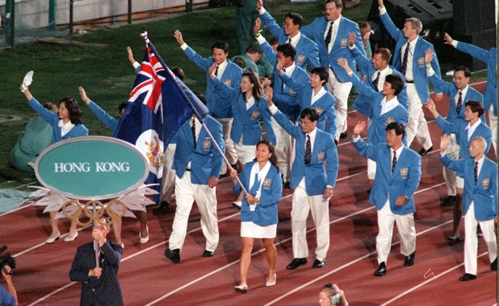 Chan Sau-ying carries the old Hong Kong flag as she leads the Kong contingent through during the territory’s final Olympic Games opening ceremony under the British Flag. Photo: David Wong