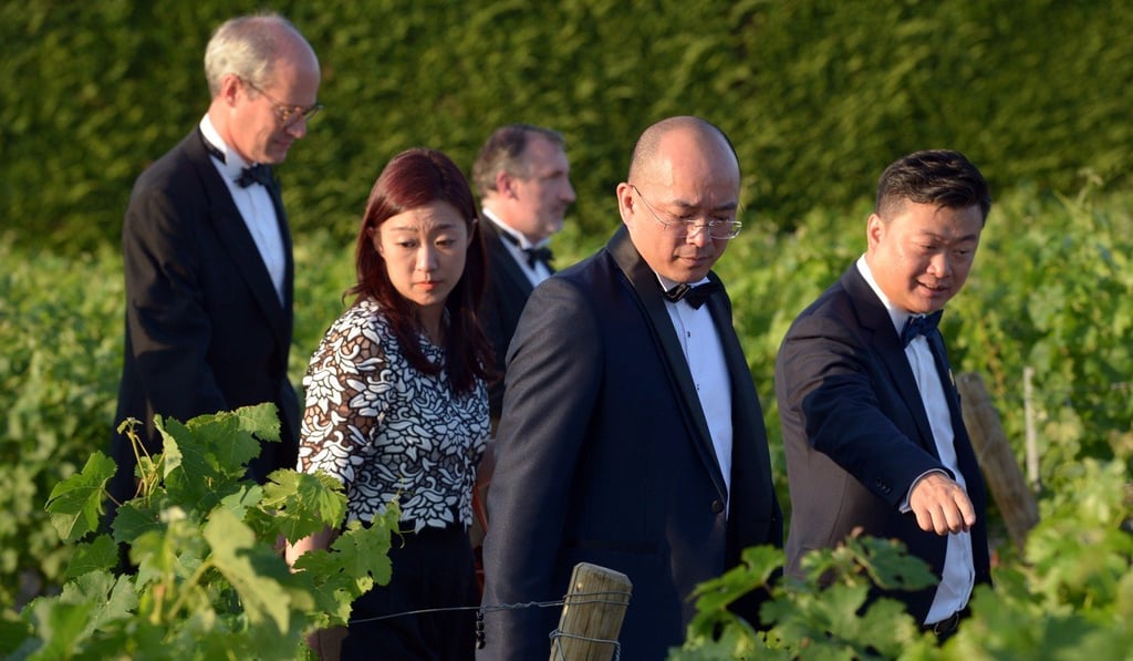 Guests walk in the vineyards during the 65th