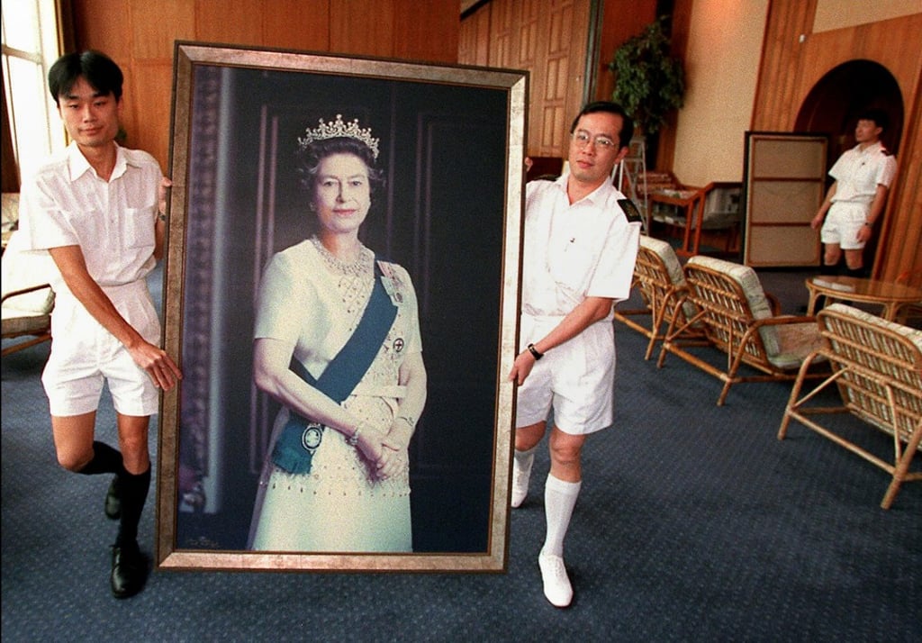 A portrait of Britain’s Queen Elizabeth is removed from the wall at the HMS Tamar, the British Forces’ Hong Kong headquarters, on June 16, 1997, ahead of the handover on July 1. Photo: AFP