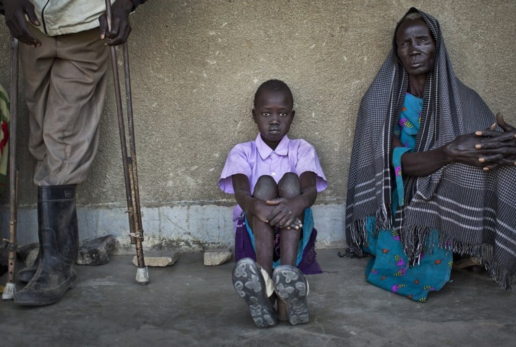 People displaced by fighting between government forces and rebel fighters in South Sudan queue for medical care at a clinic set up by NGO Medecins Sans Frontieres in a school building. Photo: AFP