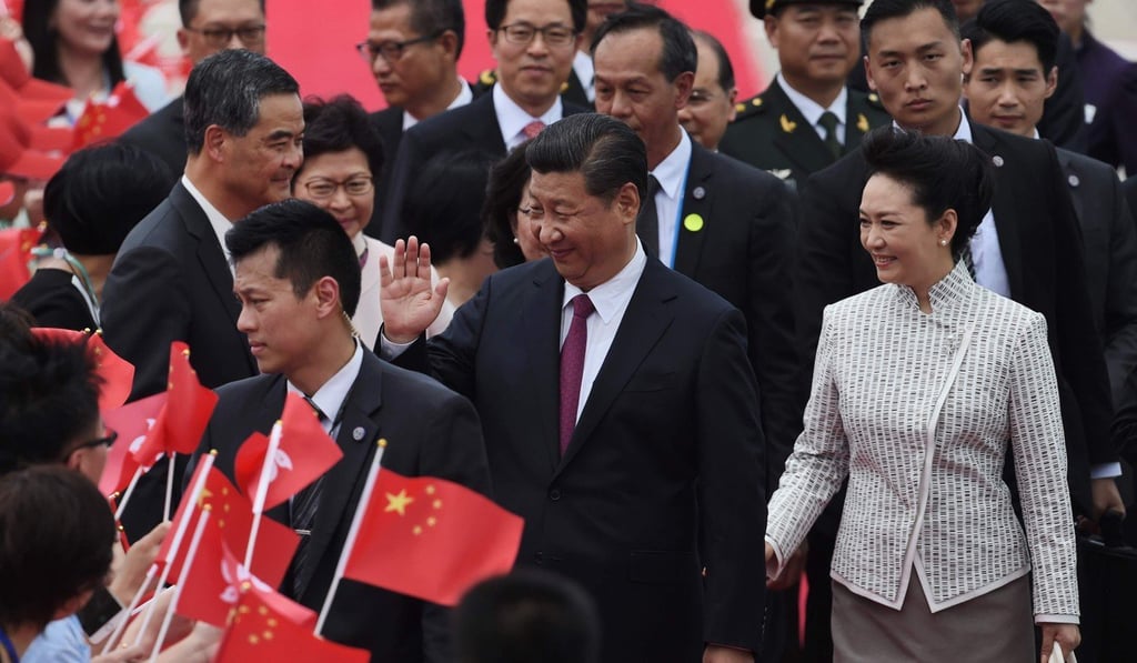 China's President Xi Jinping and first lady Peng Liyuan are greeted by Hong Kong's outgoing chief executive Leung Chun-ying and wellwishers upon their arrival at Hong Kong's international airport. Xi arrived in Hong Kong on June 29 to mark 20 years since it was handed back to China by Britain, with leading democracy activists already in police custody after a protest in the politically divided city. Photo: AFP China's President Xi Jinping and first lady Peng Liyuan are greeted by Hong Kong's outgoing chief executive Leung Chun-ying and wellwishers upon their arrival at Hong Kong's international airport. Xi arrived in Hong Kong on June 29 to mark 20 years since it was handed back to China by Britain, with leading democracy activists already in police custody after a protest in the politically divided city. Photo: AFP