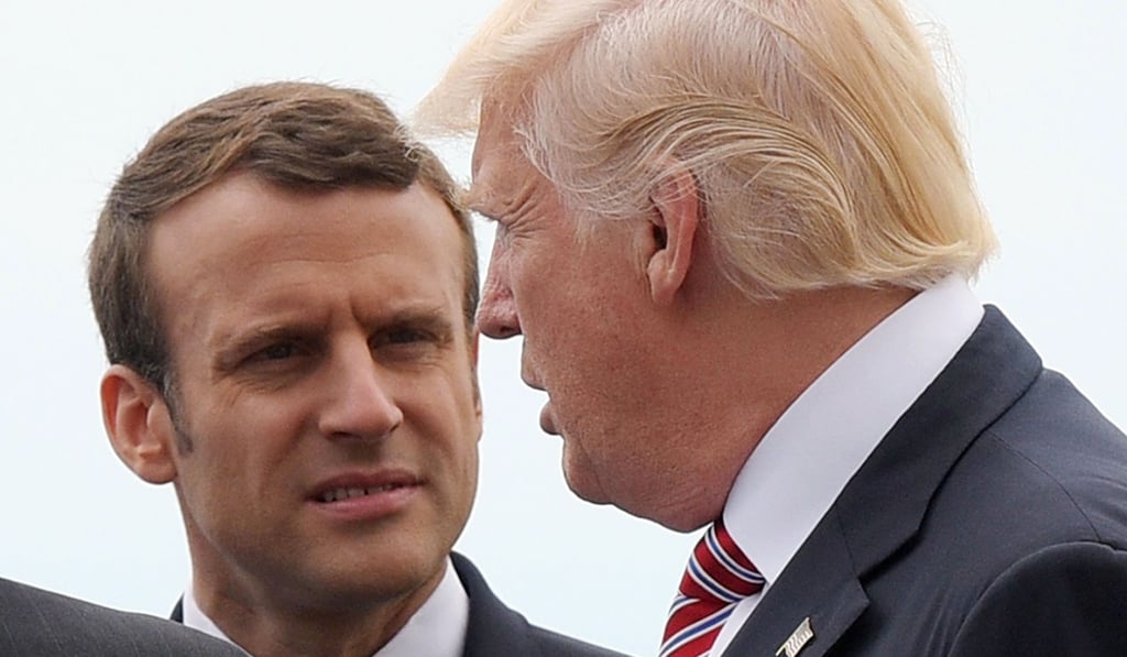 This file photo taken on May 26, 2017 shows French President Emmanuel Macron listening to US President Donald Trump during the G7 Summit in Taormina Sicily. The White House announced on June 28, 2017, that President Trump has accepted the invitation by President Macron to visit France during Bastille Day, July 14. Photo: AFP