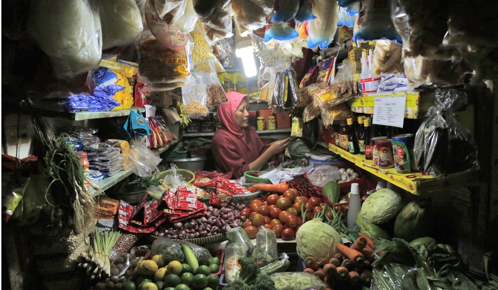 An Indonesian vendor waits for customers at a traditional market in Jakarta last month. Indonesian incomes are stagnating as reform fatigue and parochial squabbles distract Jakarta. Photo: EPA An Indonesian vendor waits for customers at a traditional market in Jakarta last month. Indonesian incomes are stagnating as reform fatigue and parochial squabbles distract Jakarta. Photo: EPA