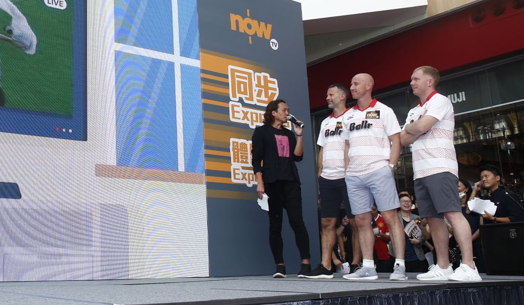 Ryan Giggs, Nicky Butt and Paul Scholes watch a demonstration of the new