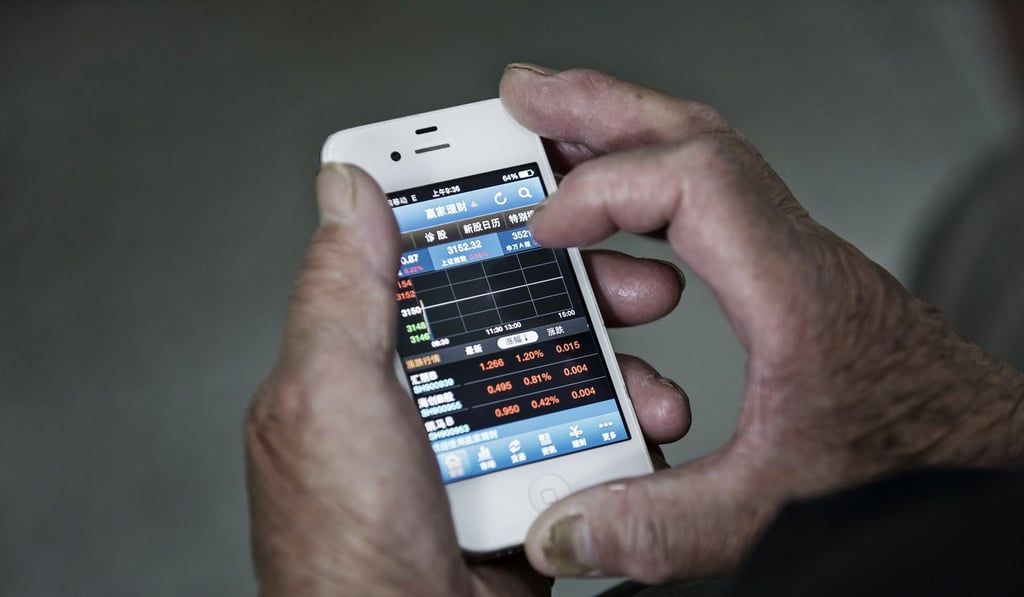 An investor uses a smartphone displaying share prices at a securities brokerage in Shanghai. Photo: Bloomberg An investor uses a smartphone displaying share prices at a securities brokerage in Shanghai. Photo: Bloomberg
